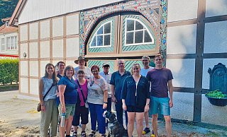 Stan Linhorst aus New-York-State (4.v.r.), mit Ehefrau, Kindern, Schwiegerkindern und den deutschen Verwandten. Der Giebel im Hintergrund gibt Auskunft über die Familienherkunft. - Familie Linhorst