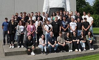Gruppenbild mit dem „Großen Knienden“ vor dem Hörmann-Forum in Steinhagen: Für 44 junge Menschen begann mit der Einführungswoche ihr Berufsleben bei Hörmann. - Hörmann
