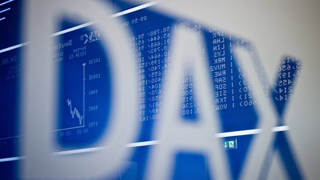Im Schriftzug «DAX» spiegelt sich die große Anzeigetafel im Handelssaal der Börse in Frankfurt am Main. | © Foto: Christoph Schmidt