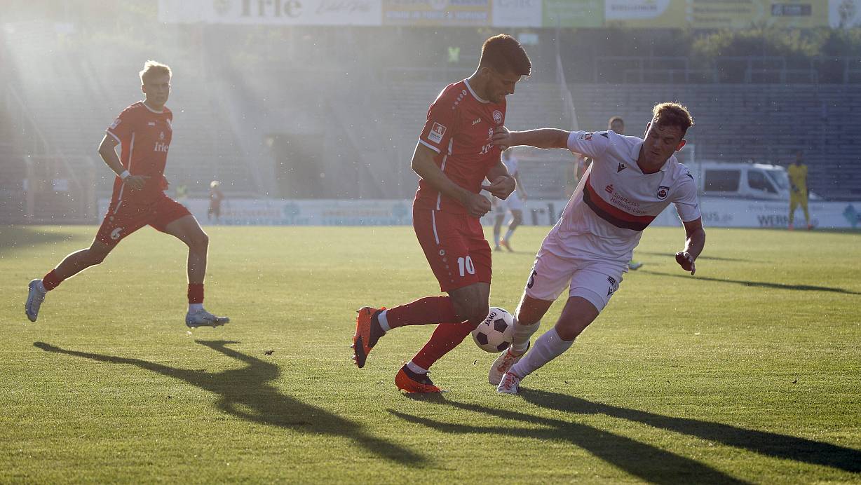 Arminias Assistenzcoach Janik Steringer (r.) liefert sich im Trikot des SV Lippstadt ein Duell mit dem Siegener Cagatay Kader. Es ist eine Szene aus dem Oberliga-Hinspiel, das die Sportfreunde im August 2024 mit 2:1 gewannen. Das Rückspiel fand vor knapp drei Wochen statt. Siegen siegte 3:0. | © IMAGO/Rene Traut