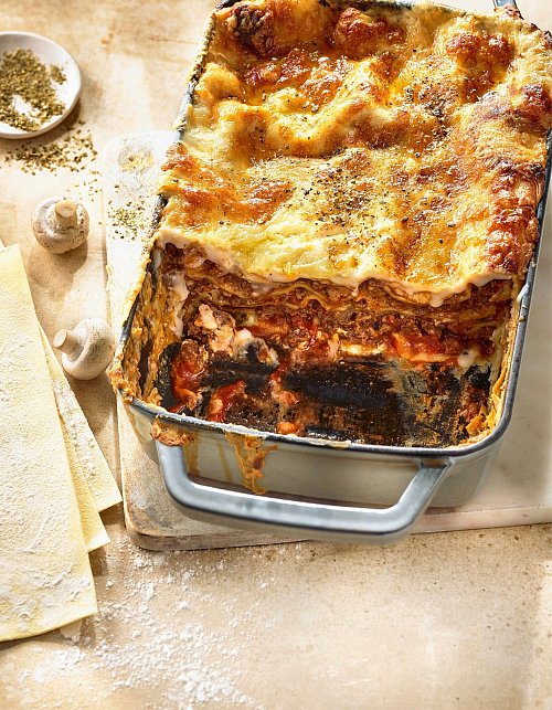 Eine tomatige, rotweinduftende Hackfleischsoße gehört für Martina Meuth in die klassische Lasagne - in ihrem Rezept sind auch noch Champignons dabei. - © Hubertus Schüler/BJVV/dpa-tmn