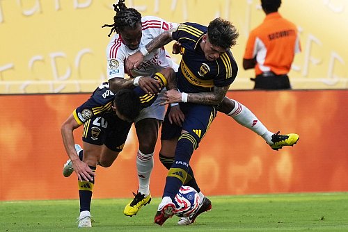 Es ging rustikal zur Sache zwischen Boca und Benfica: Hier kämpft der frühere Bayern-Profi Renato Sanches (M) von Lissabon mit Carlos Palacios (r) und Alan Velasco um den Ball. - © Rebecca Blackwell/AP/dpa