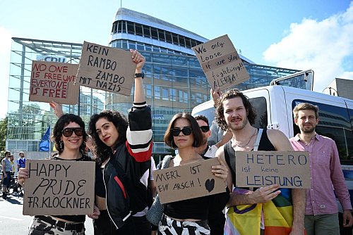 Teilnehmerinnen und Teilnehmer greifen auf ihren Plakaten auch die Kontroverse um die Regenbogenflagge am Bundestag auf. - © Bernd von Jutrczenka/dpa