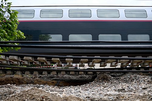 Dieser Zug musste anhalten, weil der Schotter unter den Schienen nach heftigen Regenfällen wegbrach. - © Christophe Archambault/AFP/dpa
