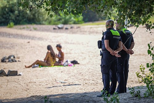 Mitarbeiter vom Ordnungsamt der Stadt Düsseldorf sind am sogenannten Paradiesstrand im Einsatz. Sie überwachen das Badeverbot im Rhein. - © Christoph Reichwein/dpa