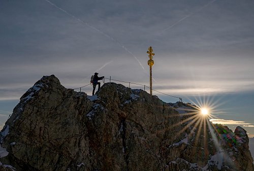 Das Gipfelkreuz ist mit Hunderten Stickern beklebt und muss restauriert werden. - © Peter Kneffel/dpa
