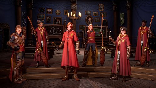 Zum Spiel gehören neben den Besen natürlich auch die roten Quidditch-Roben. - © Warner Bros./dpa-tmn