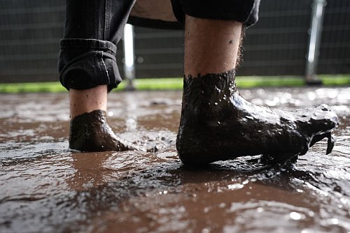 Die Besucherinnen und Besucher lassen sich von dem Wetter beim Wacken Open Air nicht abschrecken. - © Marcus Brandt/dpa