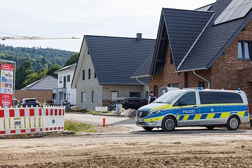 Nach Schüssen wurde ein Wohngebiet in Lübbecke bei Bielefeld von Polizisten gesichert. - © Friso Gentsch/dpa