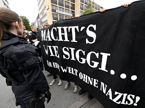 Gegendemonstranten halten in Münster ein Banner anlässlich des rechten Aufmarschs in ihrer Stadt hoch. - © Roberto Pfeil/dpa