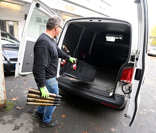 Ein Polizist transportiert Munition in Remscheid ab. - © Roberto Pfeil/dpa