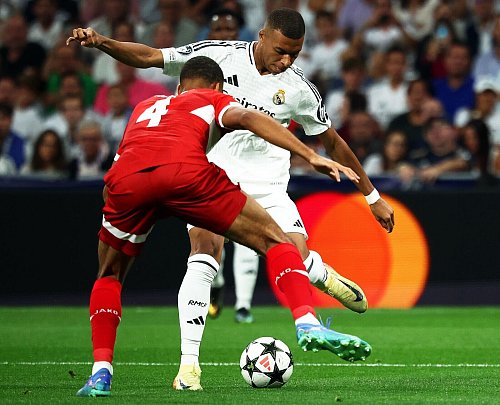 Kylian Mbappé im Zweikampf mit Josha Vagnoman. - © Jan Woitas/dpa