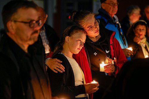 Bei der Trauerfeier an der Gedenktafel an der Evangelischen Stadtkirche, gedenken Menschen der Opfer des Terroranschlags und halten brennende Kerzen in den Händen. - © Thomas Banneyer/dpa